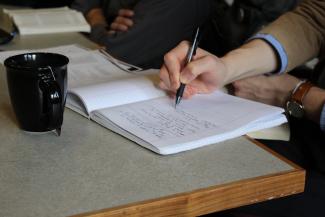 Student writing in a notebook